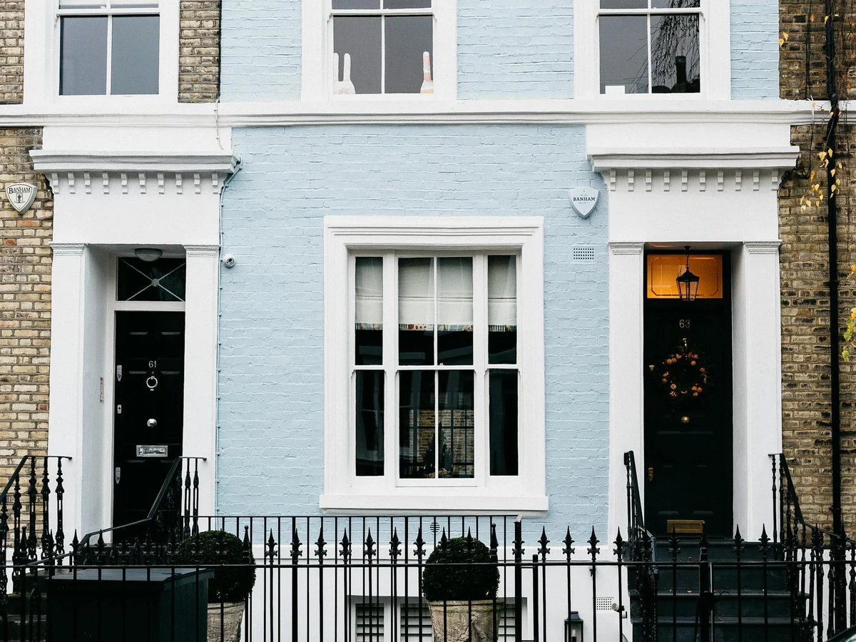 exterior-painting-light-blue-london-richmond-decorators Pale blue painted London townhouse with white window frames and a black front door