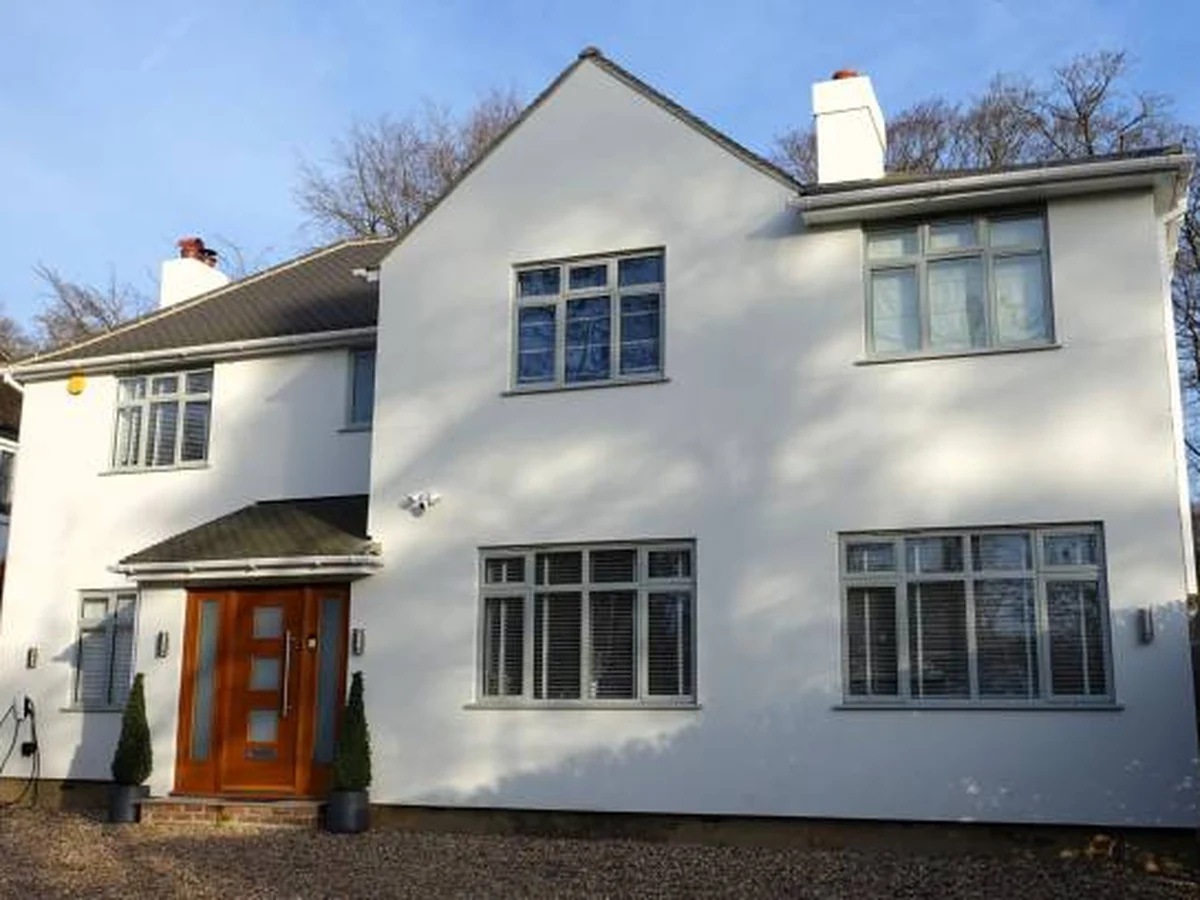 White rendered detached house exterior painting in Richmond upon Thames