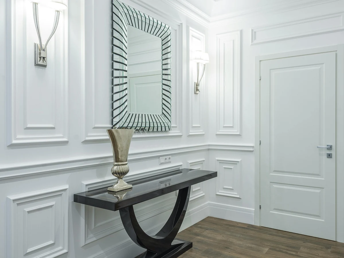Elegant white panelled hallway with freshly painted doors by Richmond Decorators