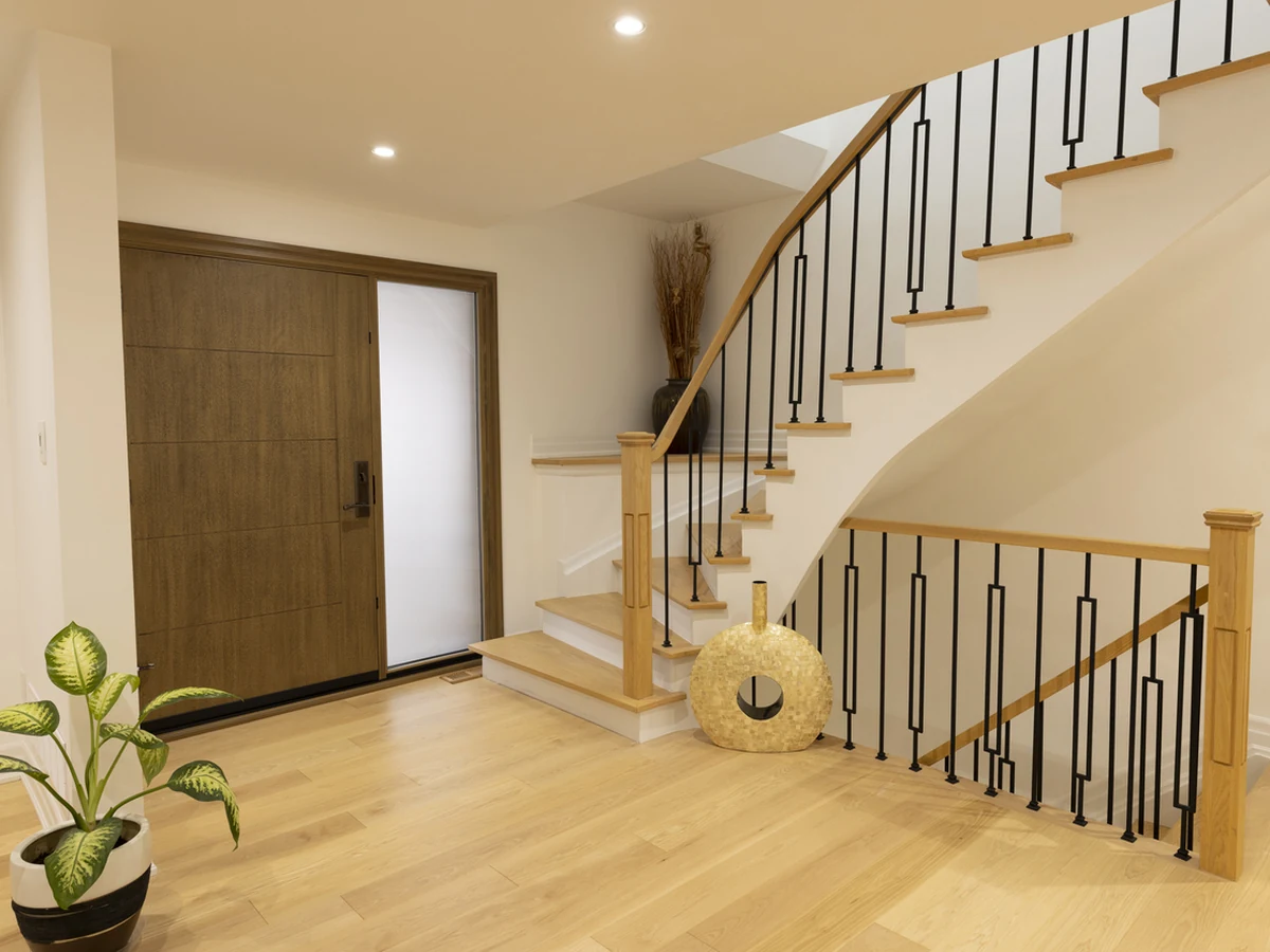 Contemporary curved hallway staircase painting with clean white finish in Richmond home