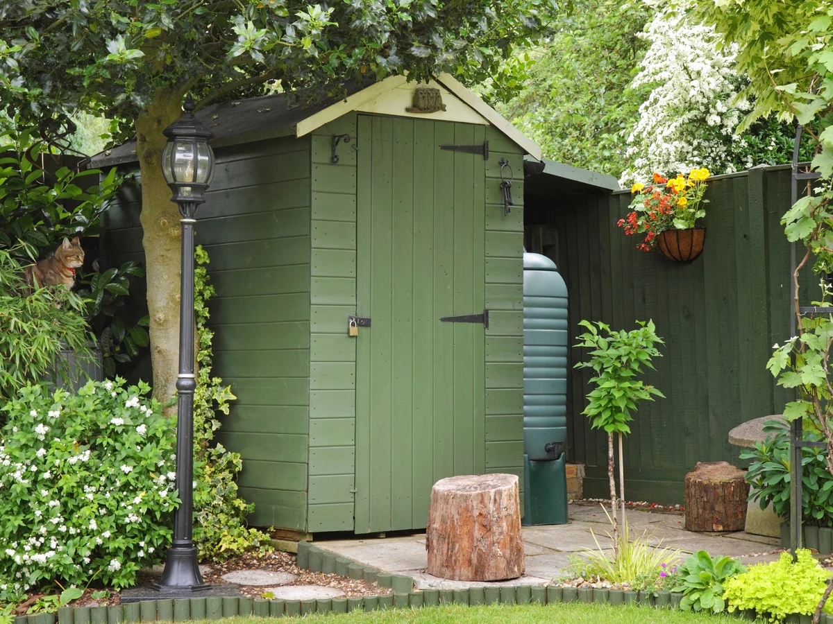 Green painted wood garden storage door in Richmond by Richmond Decorators